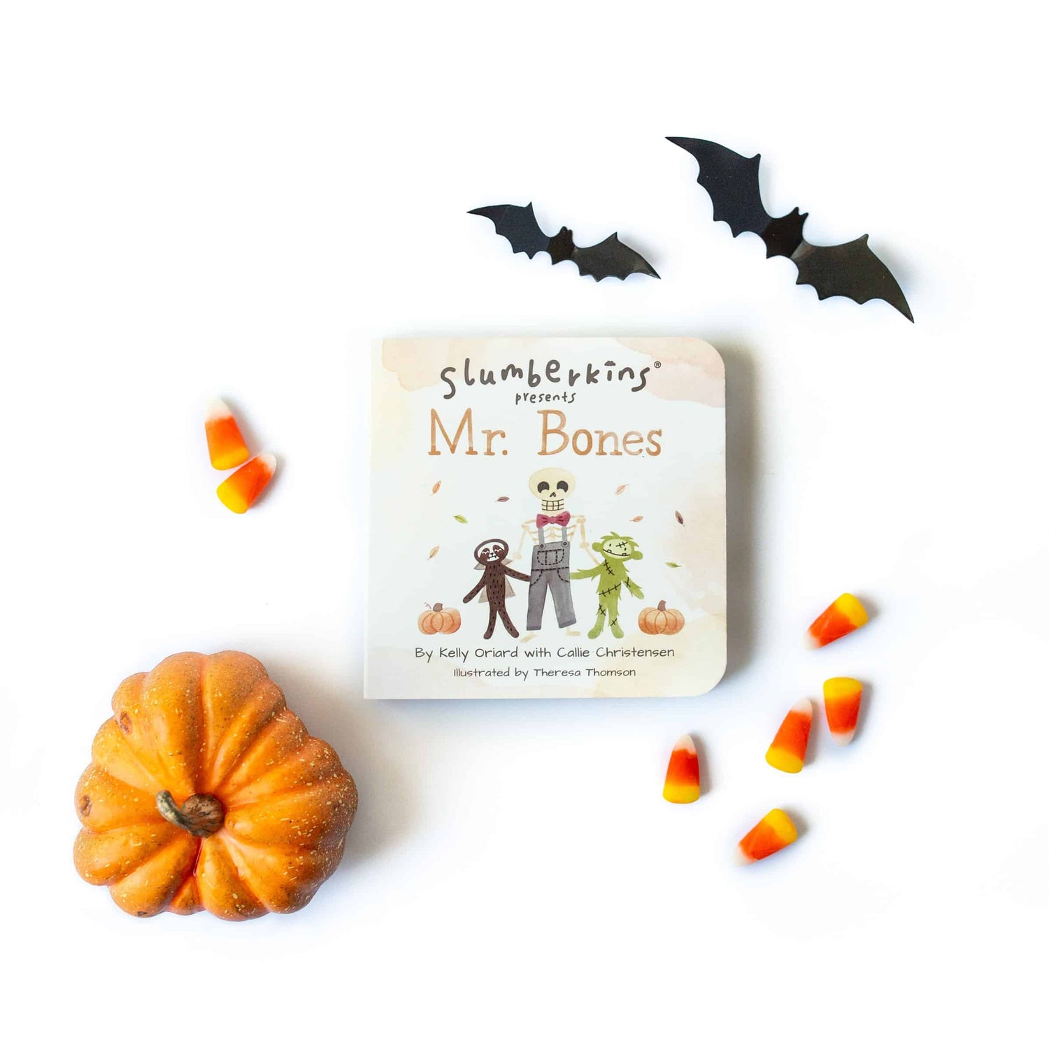 flat lay of Slumberkins Mr. Bones book surrounded by candy corn, bats, and a pumpkin